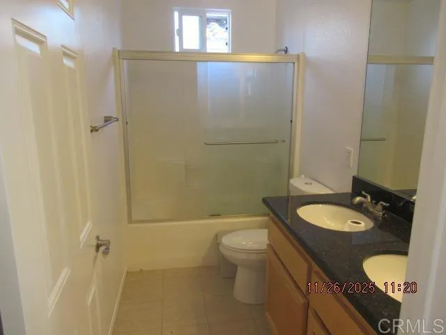 a bathroom with a granite countertop sink toilet a mirror and shower