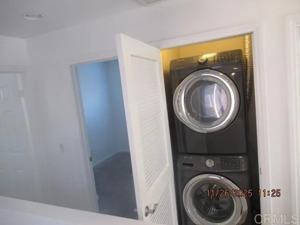 a view of a hallway with washer and dryer