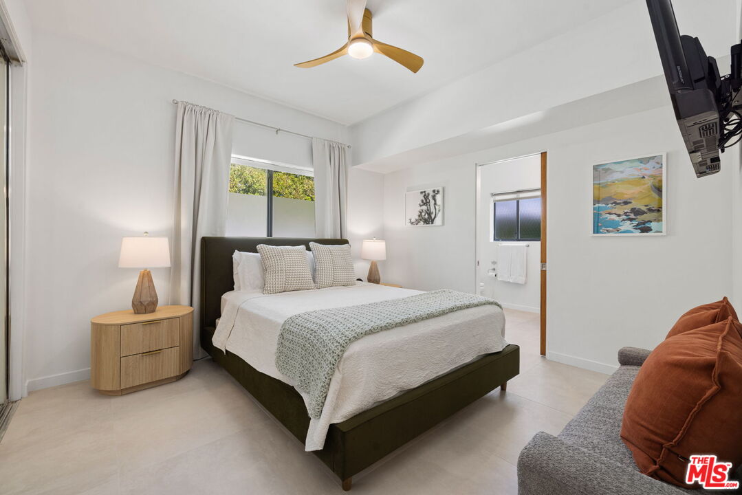 1414 Sagebrush Road Palm Springs, CA 92264 - Photo 34 of 48 a spacious bedroom with a bed and window