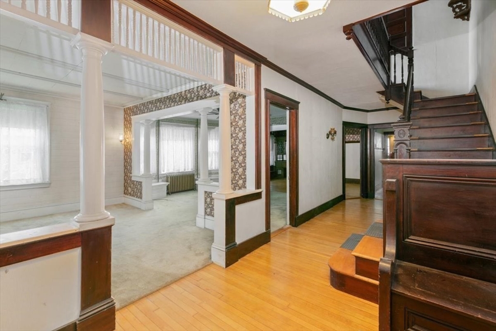 98 Webster Street Haverhill, MA 01830 - Photo 6 of 42 a view of a hallway with wooden floor and staircase