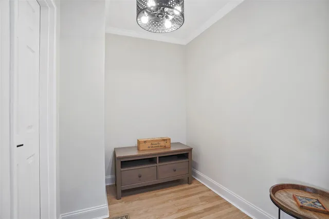 a room with a table and a chandelier