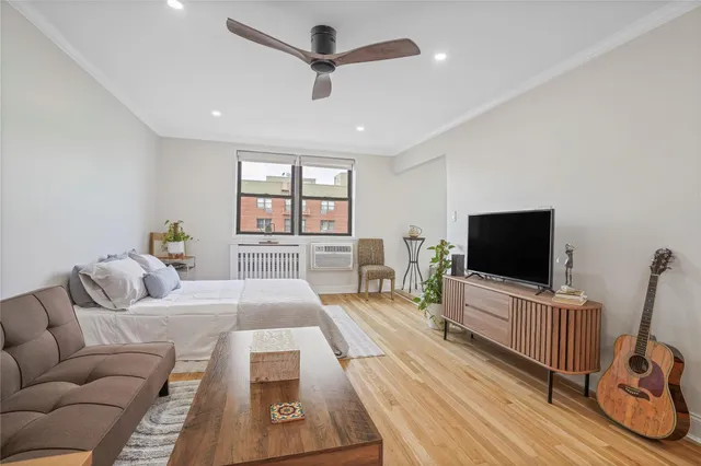 a bedroom with furniture and a flat screen tv