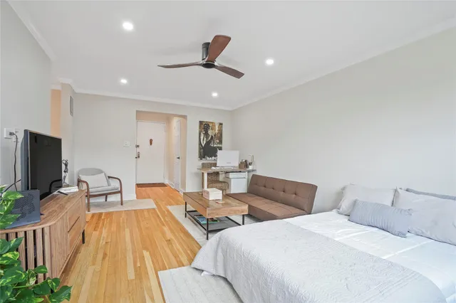 a spacious bedroom with two beds and a flat screen tv