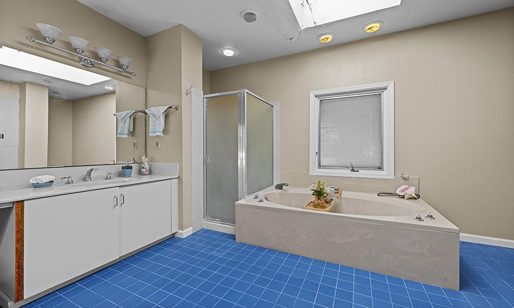 547 Mission Vineyard Road Hollister, CA 95023 - Photo 8 of 13 a bathroom with a tub double vanity sink and a mirror