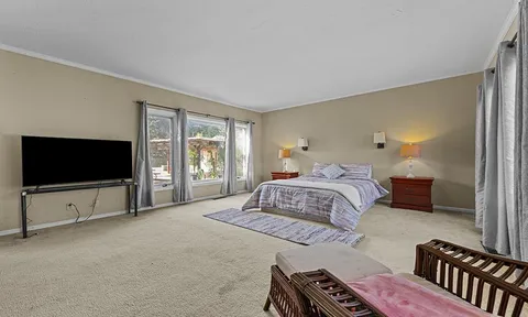 a bedroom with a bed and a flat screen tv