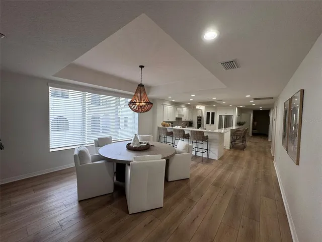 a view of a dining room with furniture window and wooden floor