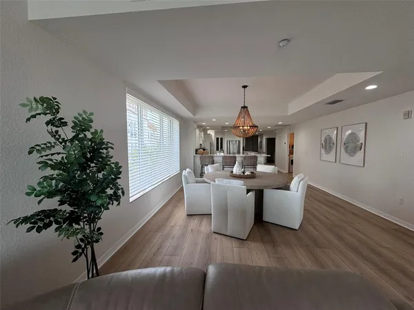 a view of a dining room with furniture window and wooden floor