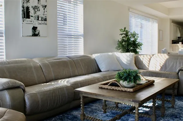 a bedroom with a large bed and a painting on the wall