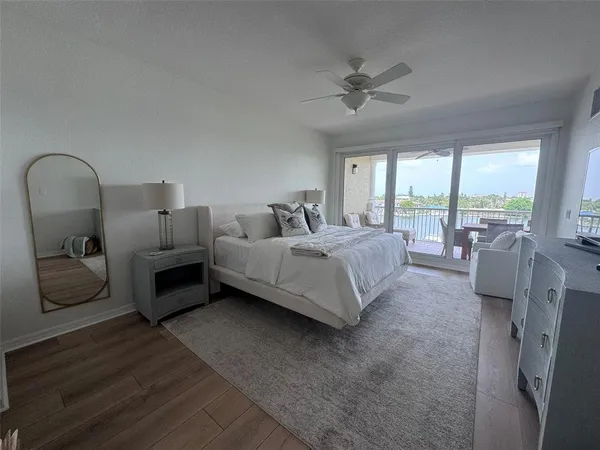 a bathroom with a granite countertop sink a mirror and shower