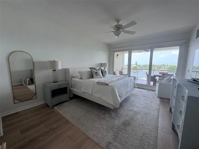 a bathroom with a granite countertop sink a mirror and shower