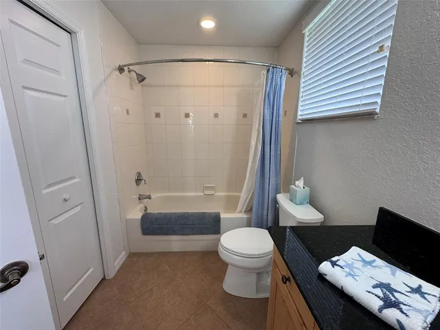 a bathroom with a toilet a mirror and a sink