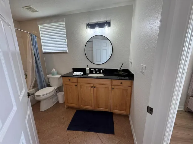 a view of a balcony with chair and wooden floor