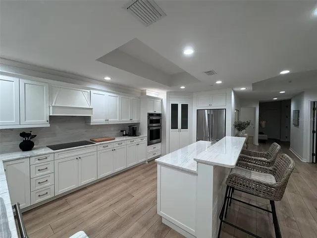 a kitchen with white cabinets and a sink