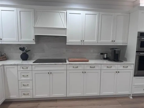 a kitchen with refrigerator and cabinets