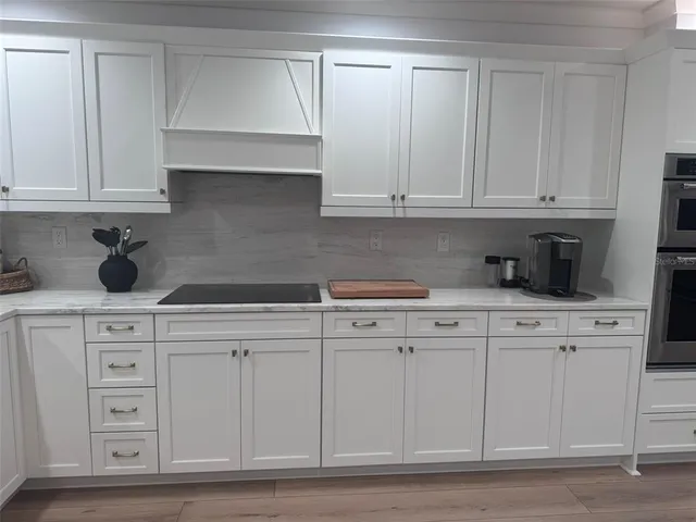a kitchen with refrigerator and cabinets