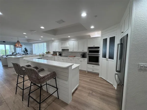 a kitchen with white cabinets and stainless steel appliances