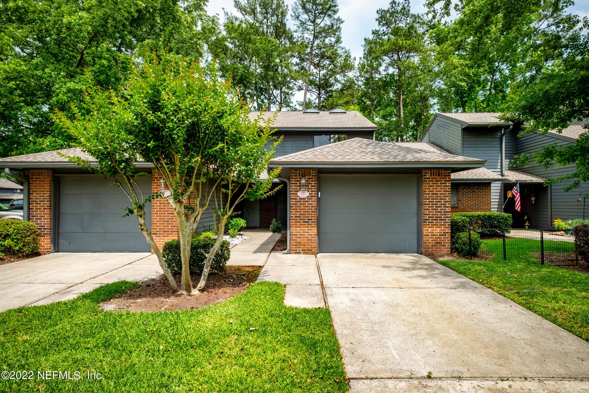 a front view of a house with a yard garage and outdoor seating