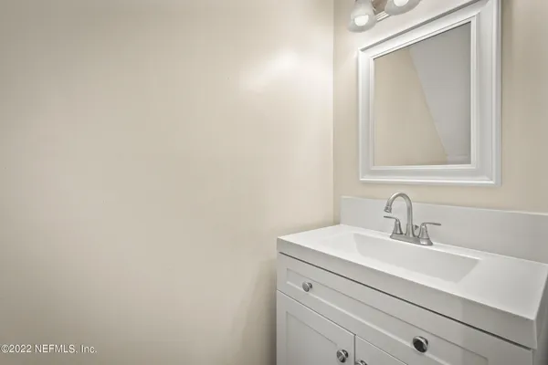 a bathroom with a sink a mirror and vanity