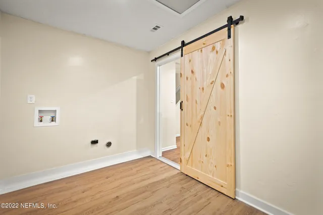 a view of an entryway with wooden floor