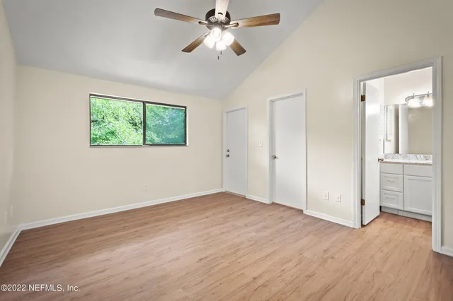 a view of an empty room with a fan