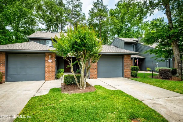 a side view of a house with a garage