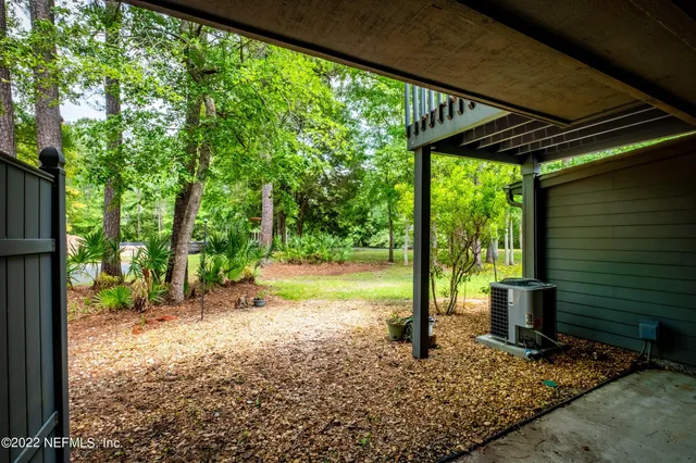 a view of a house with a yard and sitting area