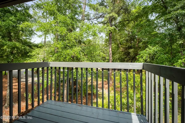a balcony with trees in front of it