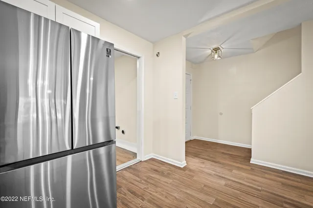 a view of a hallway with wooden floor
