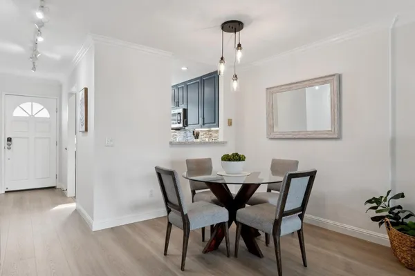 a view of a dining room with furniture and wooden floor