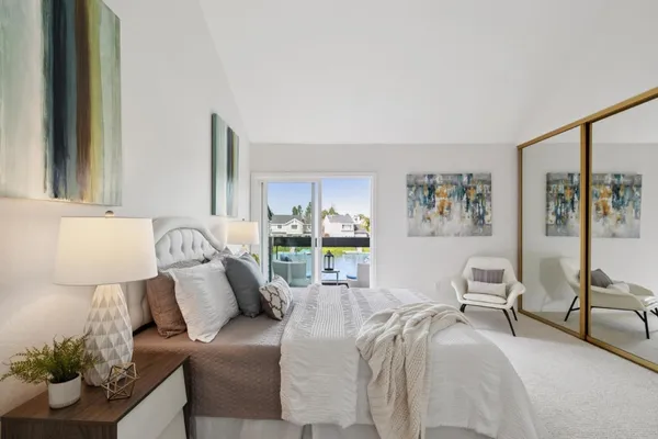 a view of a bedroom with furniture and wooden floor