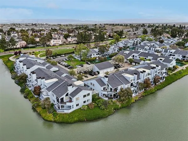 an aerial view of a house with a lake view