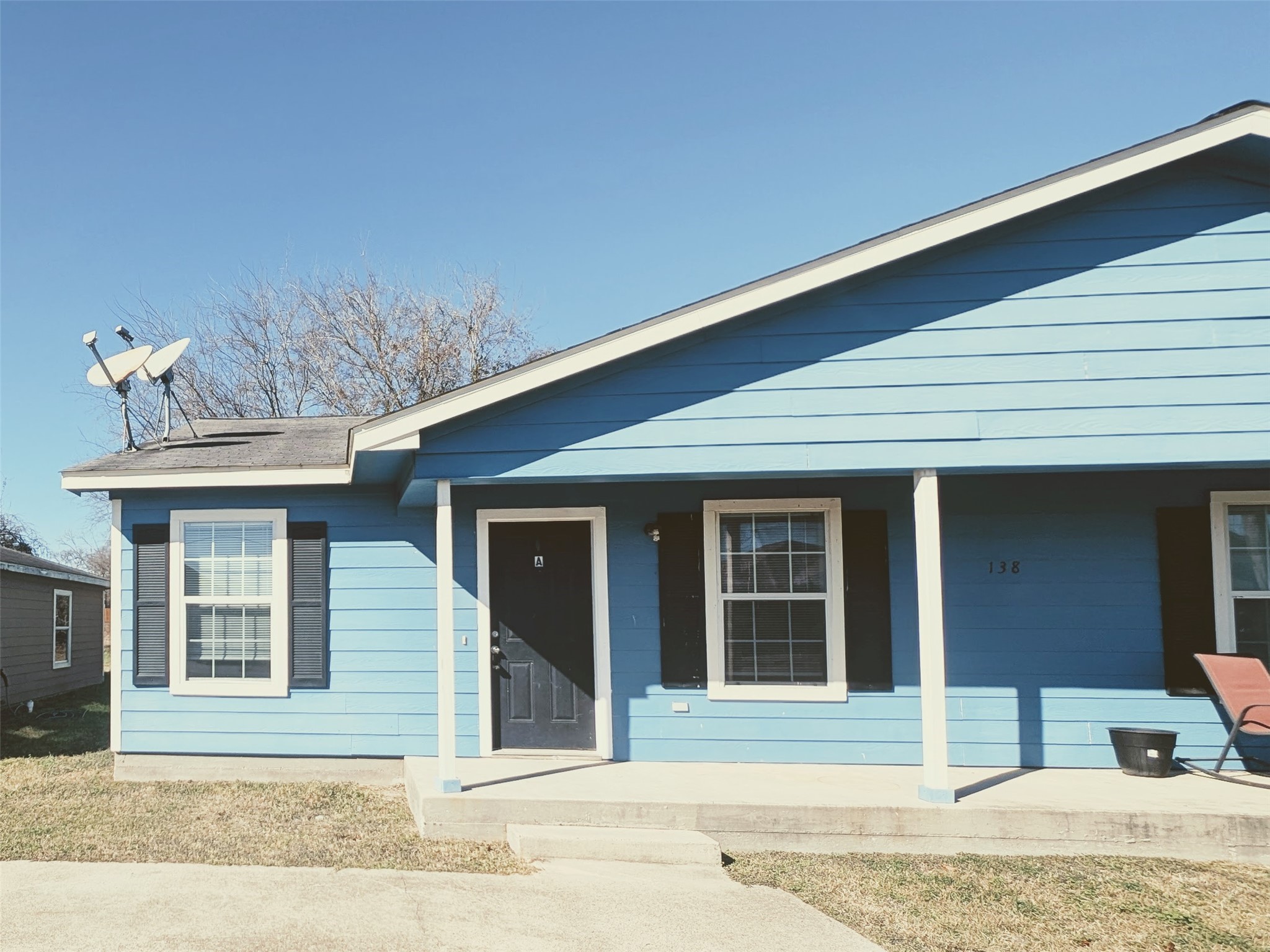 a house that has a tree in front of it