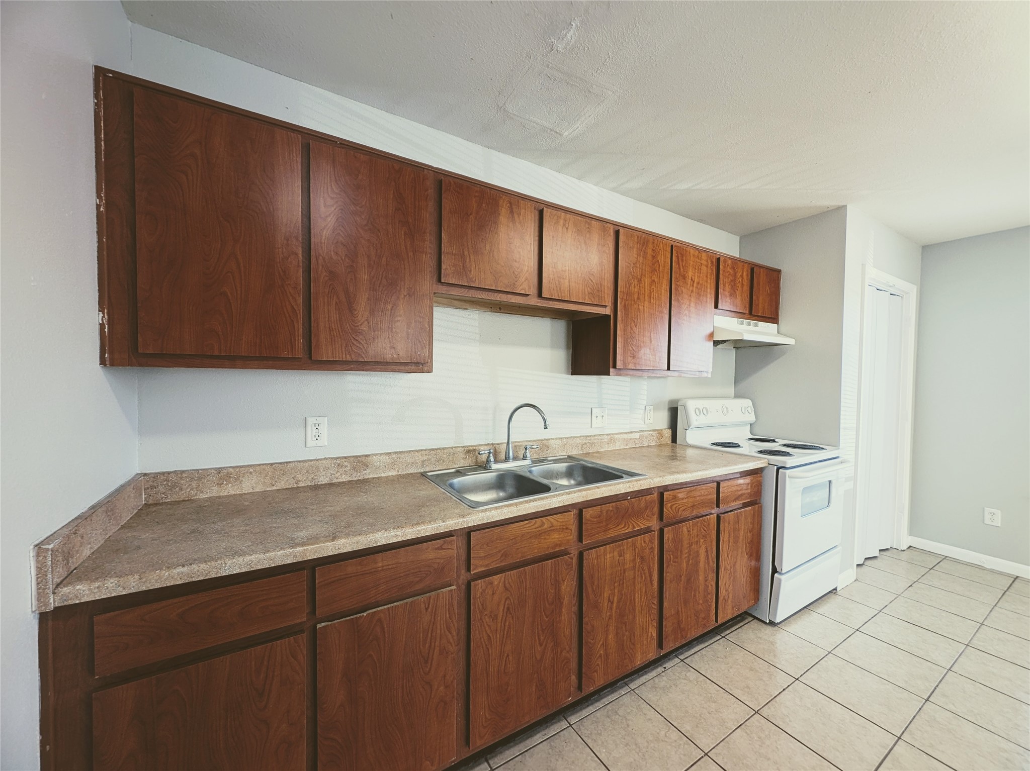 138 South Bend Court, Unit A Willis, TX 77378 - Photo 2 of 13 a kitchen with a sink and cabinets