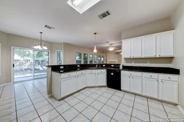 a kitchen with a sink and cabinets