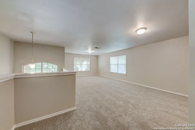 an empty room with a empty space and windows