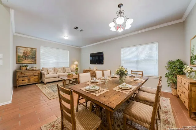 a view of a dining room with furniture and a chandelier