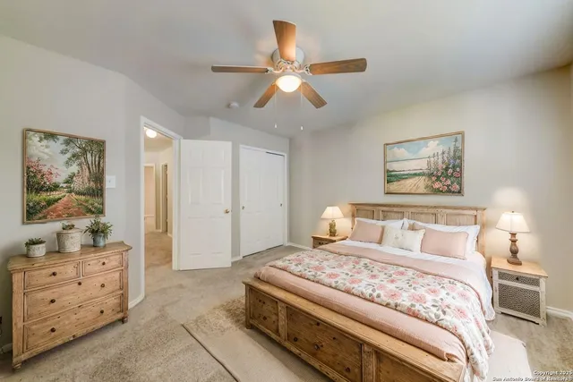a bedroom with a bed and lamp on dresser