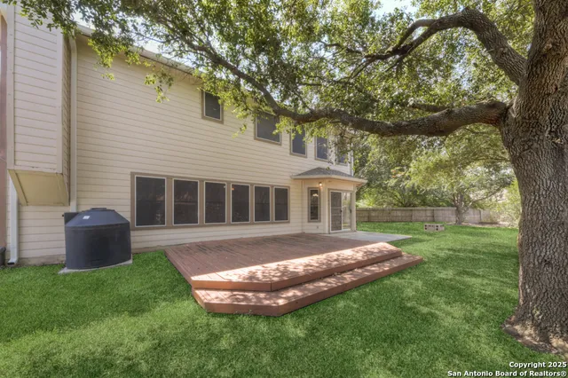 a view of house with backyard