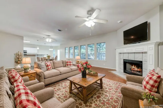 a living room with furniture fireplace and flat screen tv