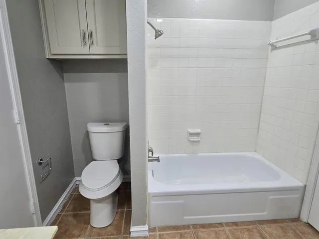 a bathroom with a toilet and a bathtub