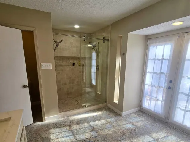 a bathroom with a shower and a tub