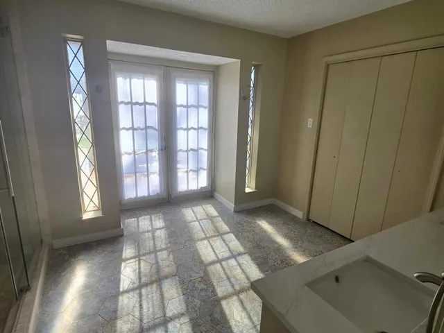 wooden floor in an empty room with windows