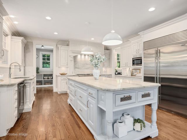 a kitchen with stainless steel appliances granite countertop a stove and a refrigerator