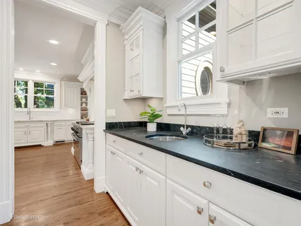 a bathroom with a tub a sink and a mirror