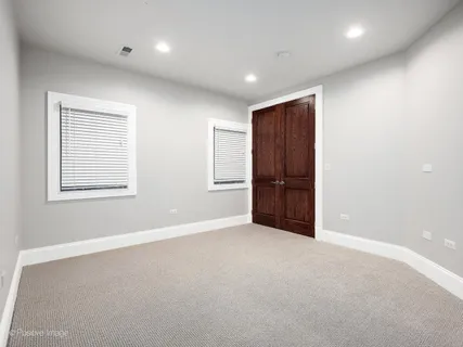 a view of a house with a small yard and large trees