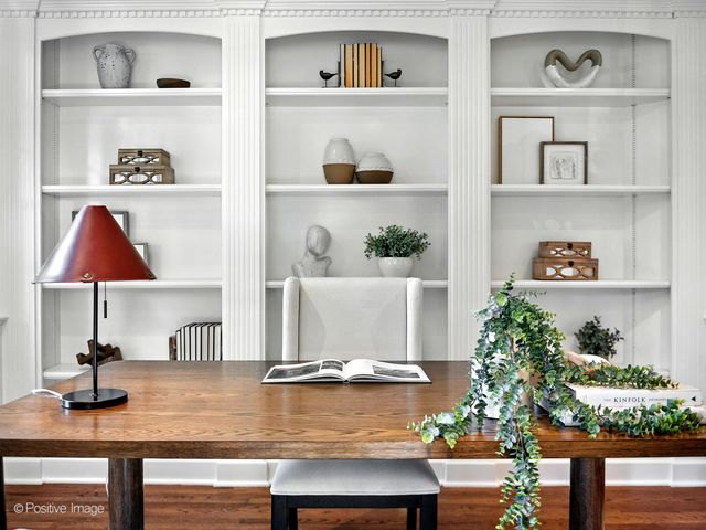 a view of an entryway with wooden floor and a large window