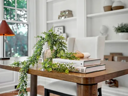 a dining room with furniture a chandelier and wooden floor