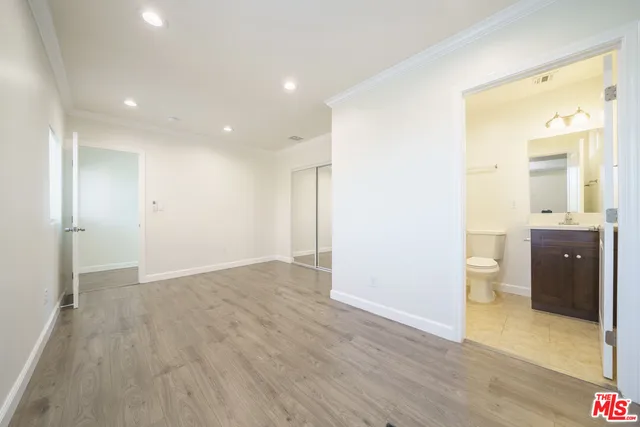 a view of an empty room and a bathroom