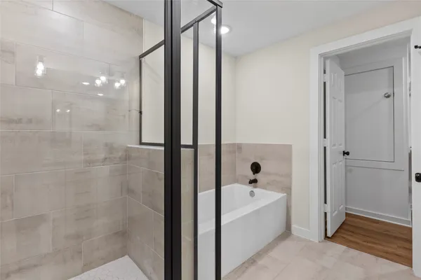 a bathroom with a bathtub and shower