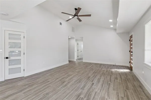 wooden floor in an empty room with a window